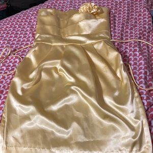 Yellow satin dress with flower bow.